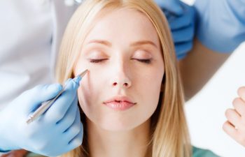 medical and plastic surgery concept - plastic surgeon and nurse with patient in hospital