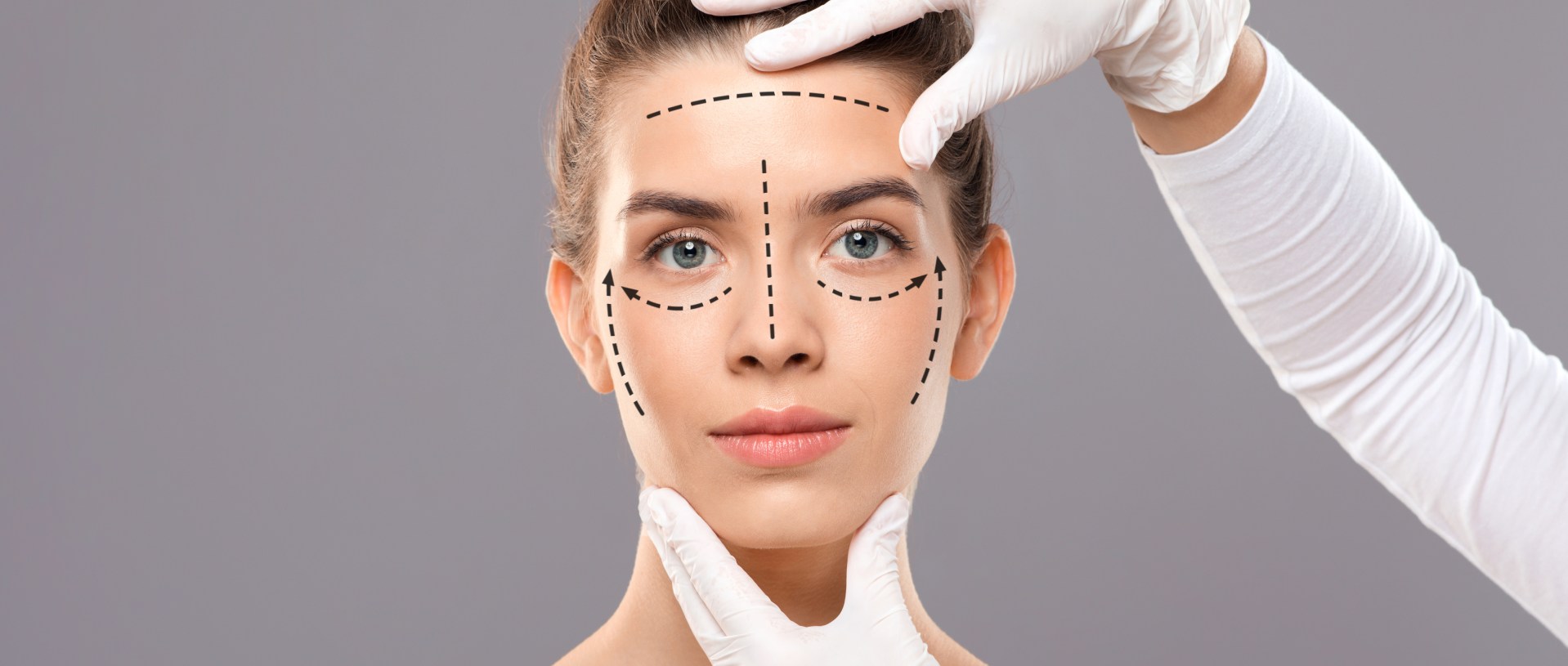 plastic surgeon making marks on beautiful lady face