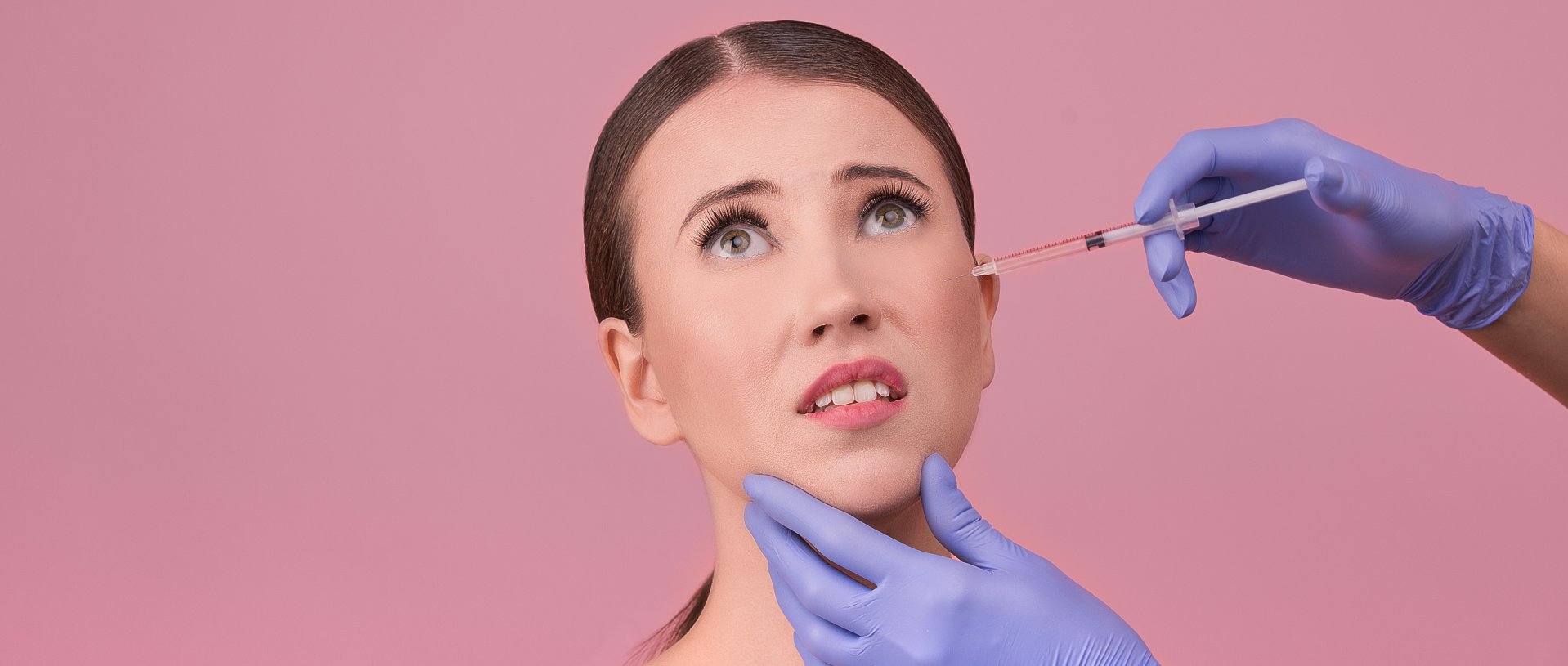 doctor makes cosmetic injection on beautiful woman face