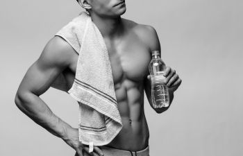 man with a towel and a bottle of water