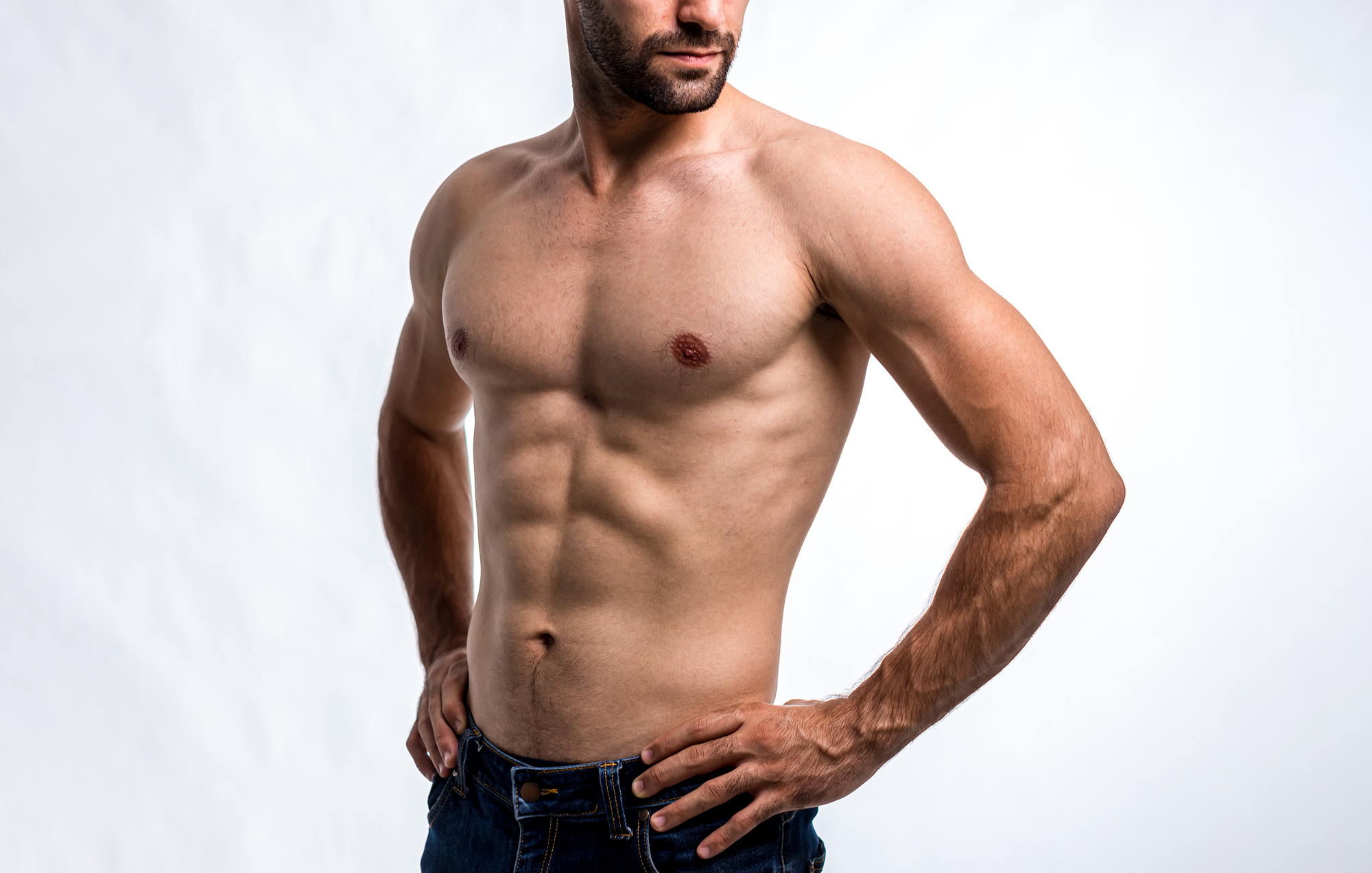 Confident athletic man after liposuction surgery.