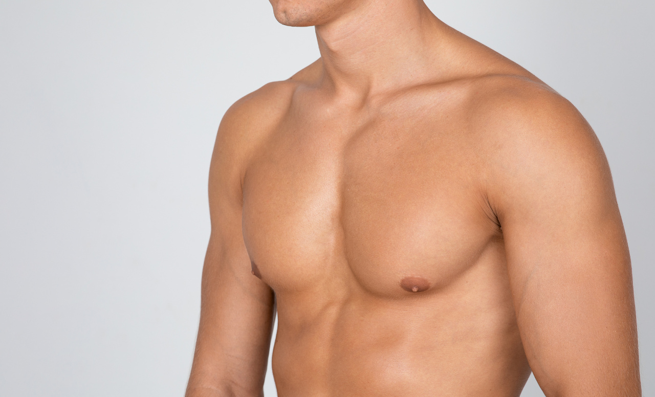 closeup of strong athletic guy with muscular naked torso showing his chest