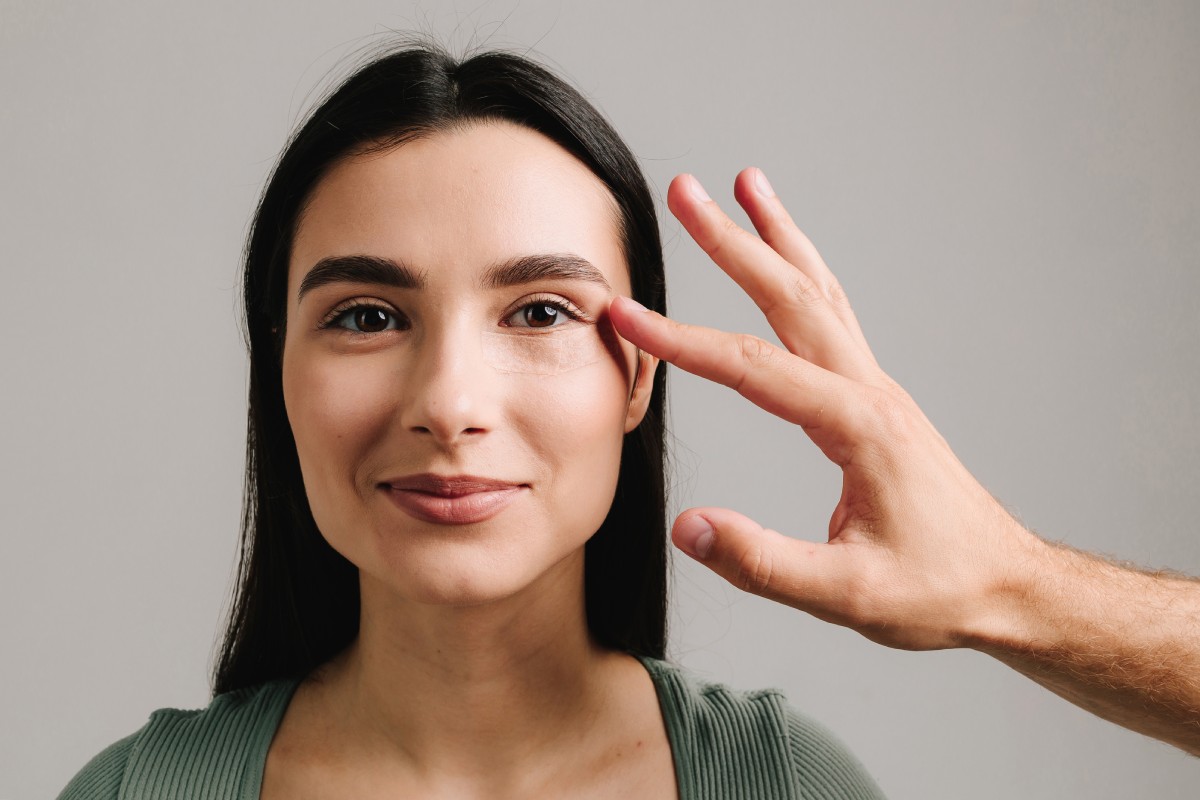 Blepharoplasty. Woman is having post-op bandage to prevent bleeding and hide traces of surgical intervention.